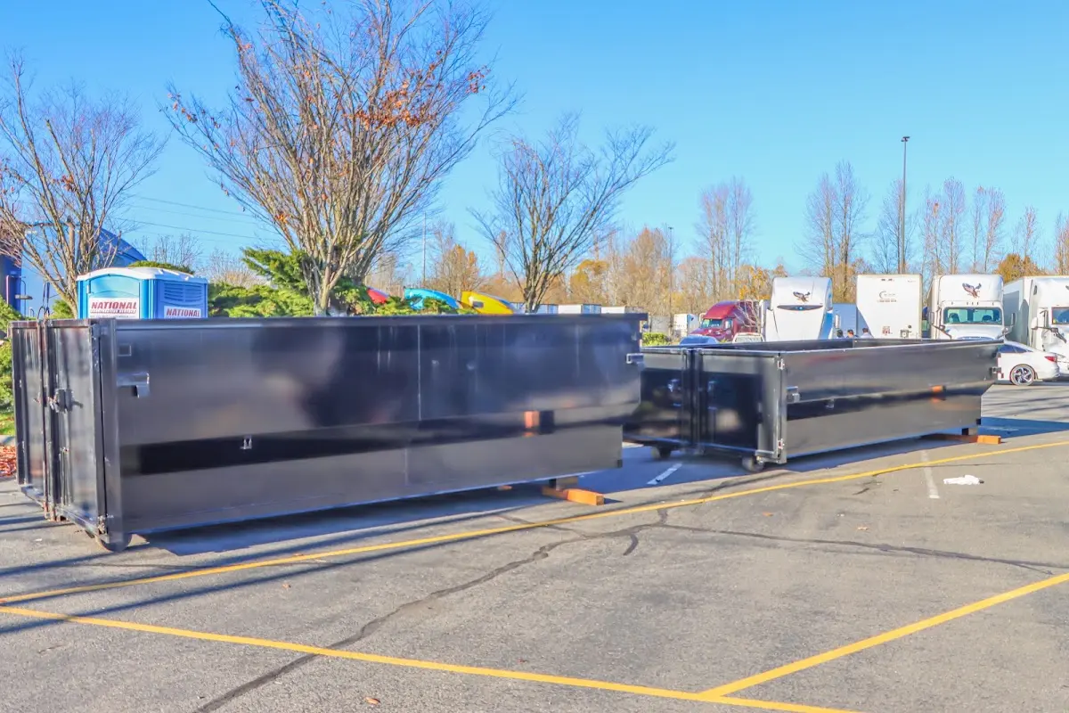 Professional dumpster rental service with roll-off container on residential driveway in Old Bridge